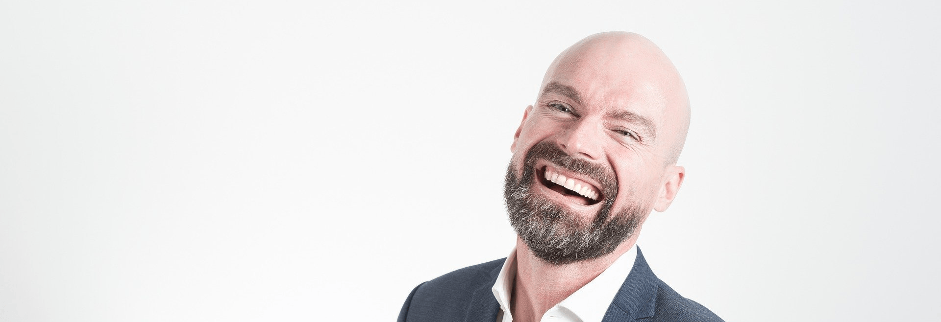 Smiling bald man with a beard.
